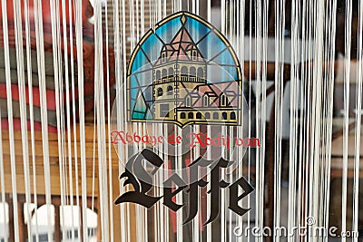 Leffe Belgian beer sign logo and brand text on door sticker bar restaurant facade Editorial Stock Photo