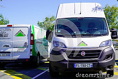 Leroy Merlin green delivery van and rent truck of decoration store chain with text Editorial Stock Photo