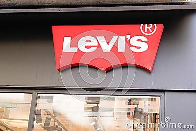 Levi`s text brand sign and red Logo front of us Jeans shop fashion boutique of clothin Editorial Stock Photo