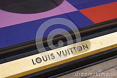 Louis Vuitton logo text and golden brand sign store street luxury facade fashion shop Editorial Stock Photo