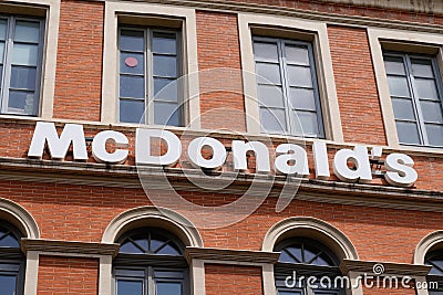 Mcdonalds sign text and logo brand front of fast food mcdonald`s restaurant building Editorial Stock Photo