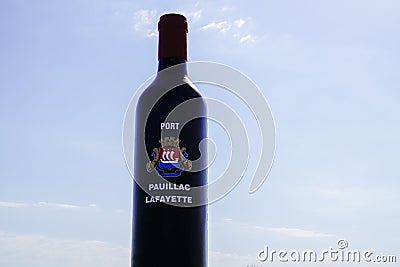 Pauillac port Lafayette text on giant bottle black red wine sign on harbor entrance Editorial Stock Photo
