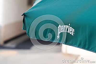 Perrier logo sign and text on terrace bar sell sparkling Natural Mineral Water from Editorial Stock Photo