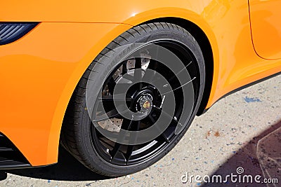 Porsche logo brand and text sign on front black wheel and tyre of sport luxury 911 car Editorial Stock Photo