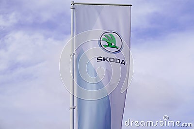 Skoda store dealership sign and text logo on flag on wind of car Czech automobile Editorial Stock Photo