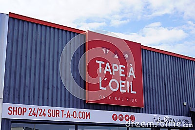 Tape a l`oeil logo and text sign front of shop of original kids and baby signage in Editorial Stock Photo