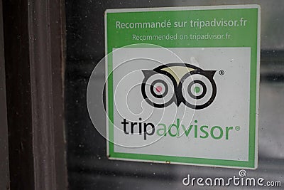 Tripadvisor logo and sign text on windows store front of entrance restaurant in Editorial Stock Photo