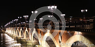 Bordeaux french city pont de pierre old stone bridge at night with town light Stock Photo