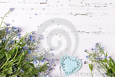 Border from blue forget-me-nots or myosotis flowers and heart Stock Photo