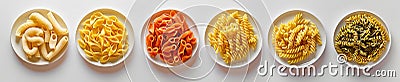 A border of different types of pasta in plates arranged in a line white isolated Stock Photo