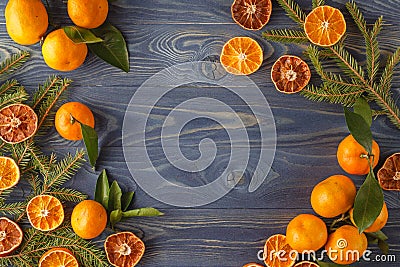 Border, frame from Christmas tree fir branches, dried orange fruit slice on old wooden desk table background. Big copyspace for h Stock Photo
