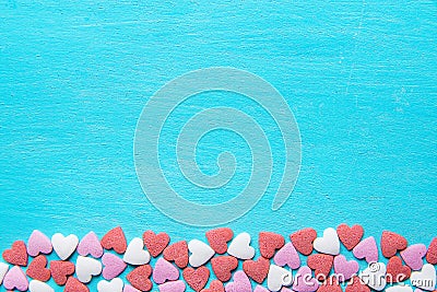 Border Frame from Colorful Sugar Sprinkles Candies Scattered on Light Blue Background. Valentine Romantic Birthday Charity Stock Photo