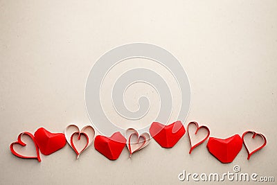 Border frame from red origami paper hearts on gray background. Valentine`s Day absctract. Symbol of love. Copy space, flat lay Stock Photo