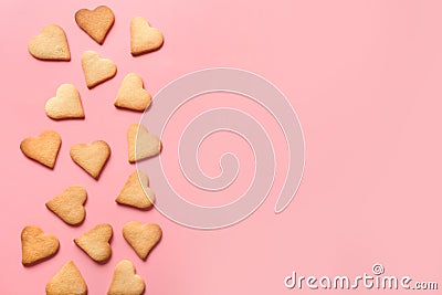 Border of homemade heart shaped cookies on pink. Flat lay Stock Photo