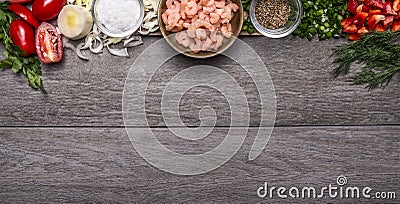 Border with shrimp with spices and vegetables and herbs on wooden background top view Banner for website Stock Photo