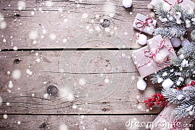 Border from wrapped christmas presents, fur tree branches, red b Stock Photo