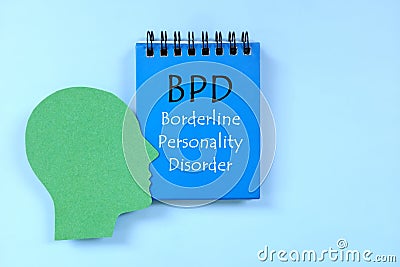 Borderline personality disorder or BPD diagnosis written on notepad in blue background. Stock Photo