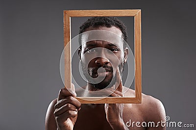 Bored afro American man holding a photo frame Stock Photo