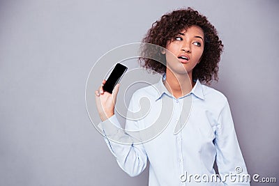 Bored afro american woman holding smartphone Stock Photo