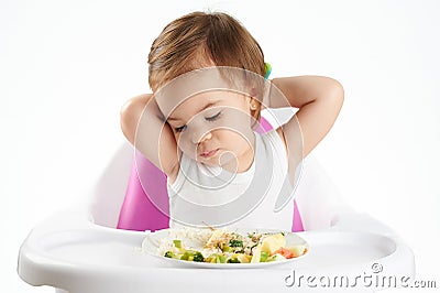 Bored baby girl with food Stock Photo