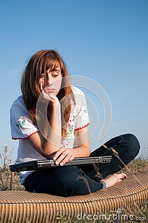 Bored Beautiful girl with computer Stock Photo