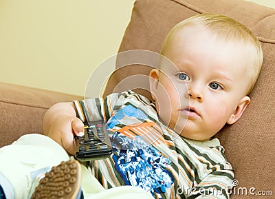 Bored boy watching TV Stock Photo