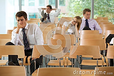 bored Business executives sitting in conference room Stock Photo