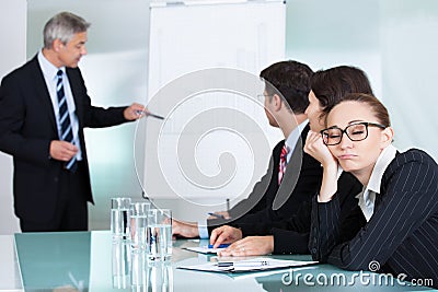 Bored businesswoman sleeping in a meeting Stock Photo