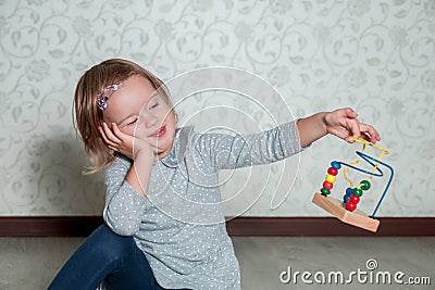 Bored. Child playing with maze. Little girl solve puzzles. Stock Photo