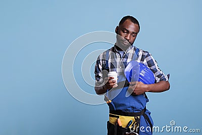 Bored construction employee drinking coffee Stock Photo