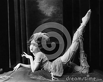 Bored dancer posing in beaded costume Stock Photo