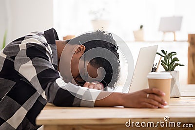 Bored exhausted african american woman falling asleep sleeping at workplace Stock Photo