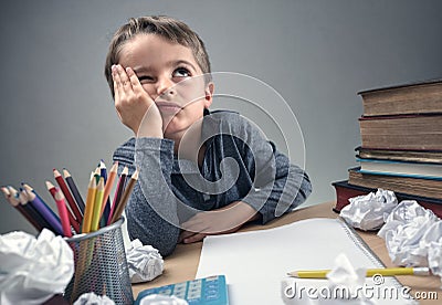 Bored and fed boy up doing his homework Stock Photo