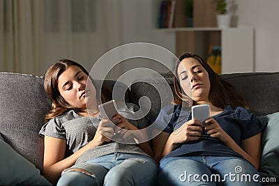 Bored friends using their smart phones Stock Photo