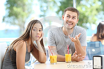 Bored girl listening a bad conversation from a friend or partner Stock Photo