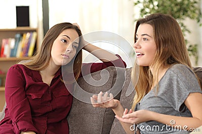 Bored girl listening to her friend having a conversation Stock Photo