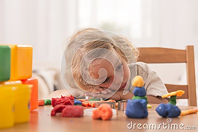 Bored girl with plasticine toys Stock Photo