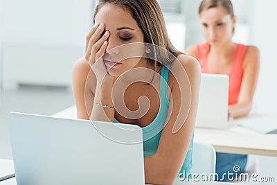 Bored girl sitting at school desk Stock Photo