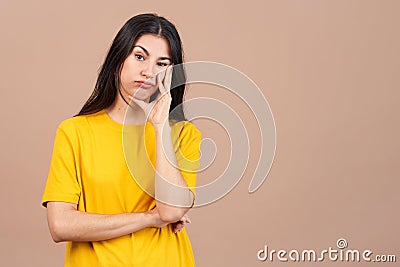 Bored hispanic woman standing and looking at the camera Stock Photo