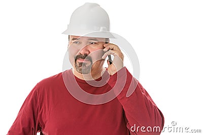 Bored looking workman chatting on his mobile Stock Photo