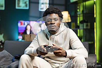 Bored person in living room plays online videogame Stock Photo