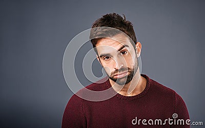 Bored, portrait and annoyed man in studio unhappy and moody against a grey background space. Sad face of depression and Stock Photo