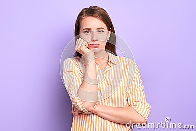 Bored pretty girl holding hand under chin, tired to wait for something for so long Stock Photo