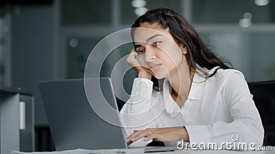 Bored sad lazy young indian woman manager sitting in office unmotivated uninterested in boring laptop work overworked Stock Photo