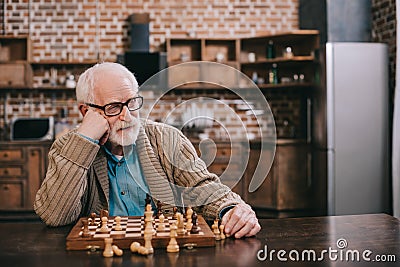 Bored senior man playing Stock Photo