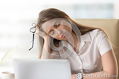 Bored sleepy businesswoman sitting half asleep at workplace, bor Stock Photo