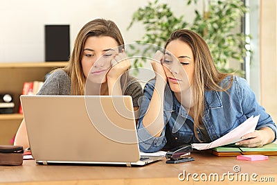 Bored or tired students doing homework Stock Photo