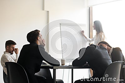 Bored unmotivated diverse team of employees feeling lack of interest. Stock Photo