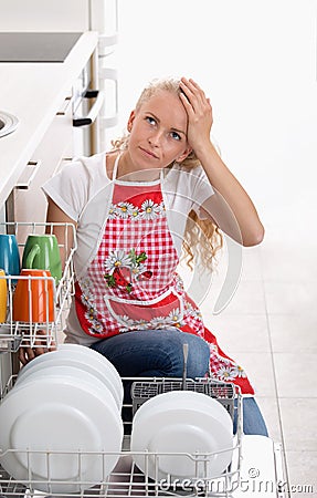 Bored woman with dishwasher Stock Photo