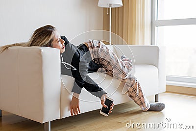 Bored woman lying in sofa Stock Photo